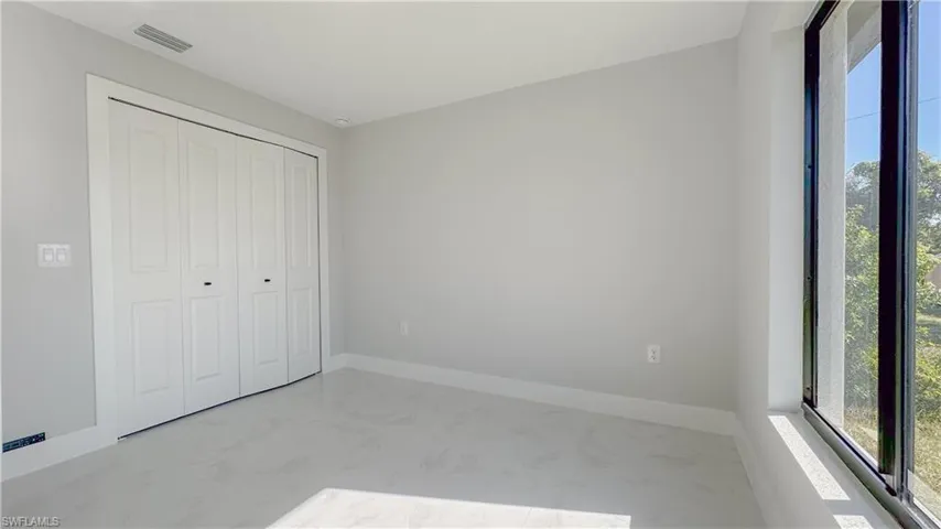 Unfurnished bedroom featuring a closet and tile patterned floors