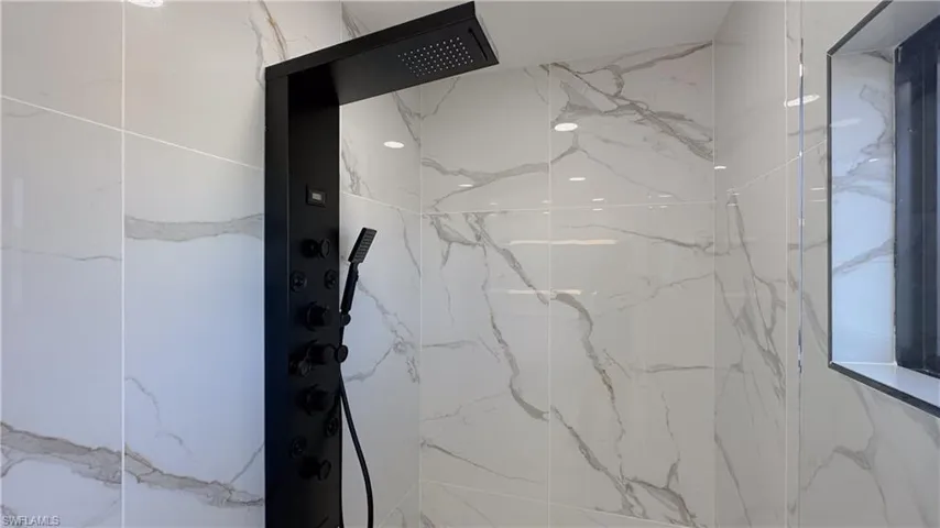 Room details with a tile shower