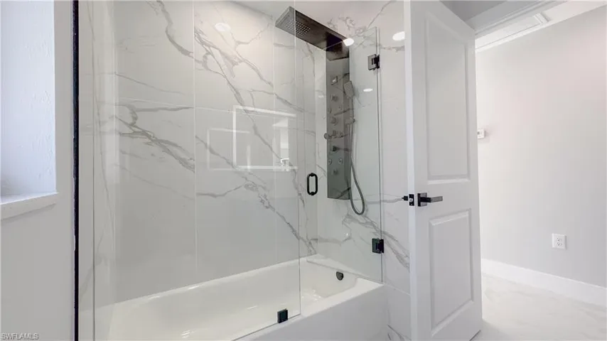 Bathroom featuring enclosed tub / shower combo