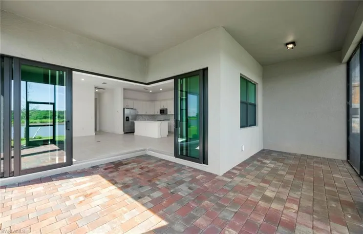 Extended covered lanai on the water - zero-corner sliders to connect indoor and outdoor space