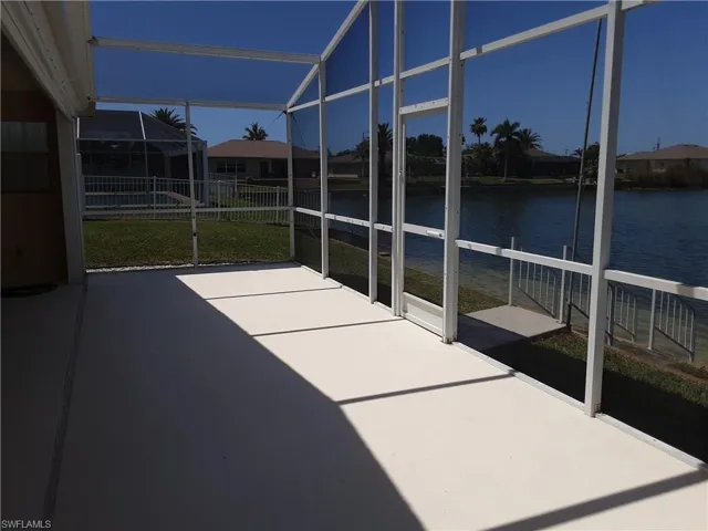 Unfurnished sunroom featuring a water view