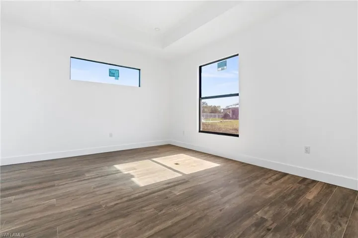 Empty room featuring dark wood-type flooring