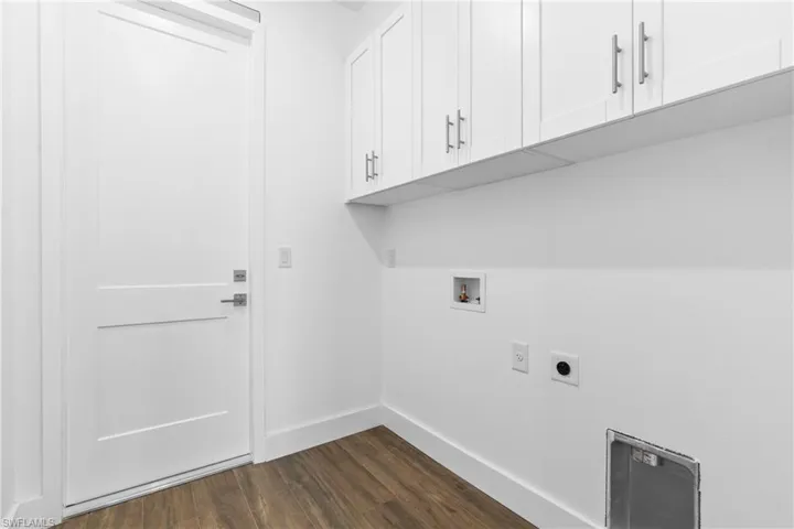 Laundry room with electric dryer hookup, cabinets, dark wood-type flooring, and hookup for a washing machine