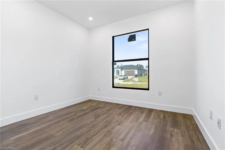 Unfurnished room with dark hardwood / wood-style floors