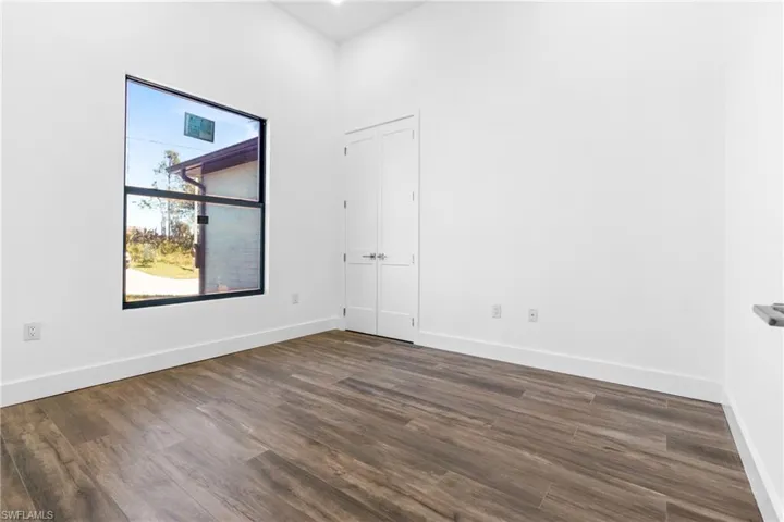 Unfurnished room with dark hardwood / wood-style floors