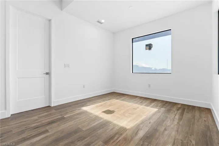 Empty room with wood-type flooring
