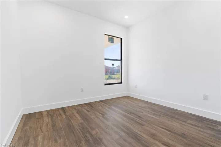 Empty room with dark hardwood / wood-style floors