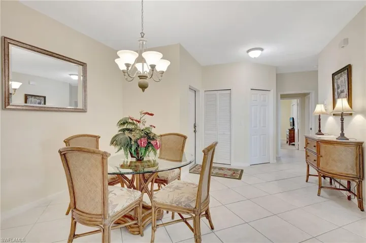 Dining room with baseboards, an inviting chandelier, and light tile patterned floors
