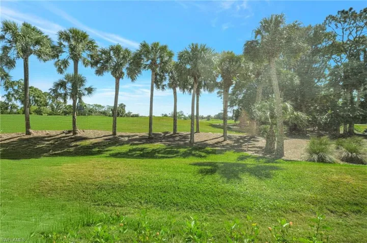 View of home's community with a lawn