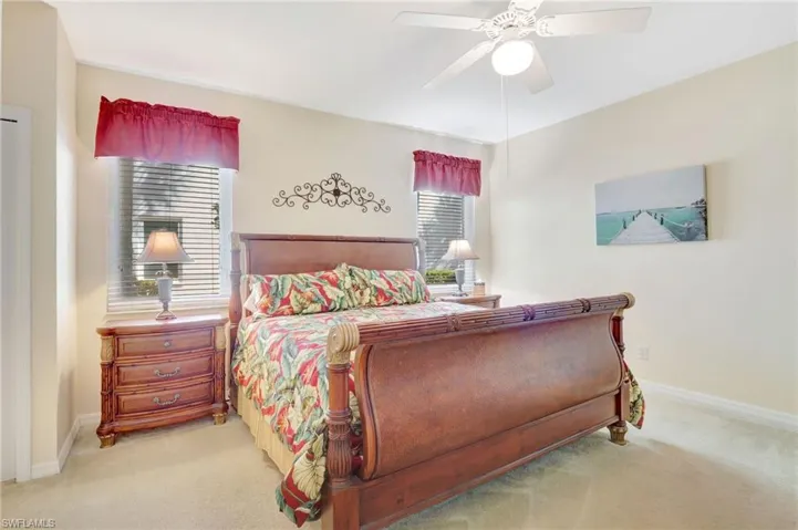 Bedroom with baseboards, carpet flooring, and ceiling fan
