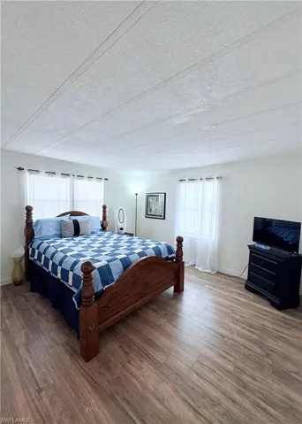 Bedroom featuring wood finished floors and a textured ceiling