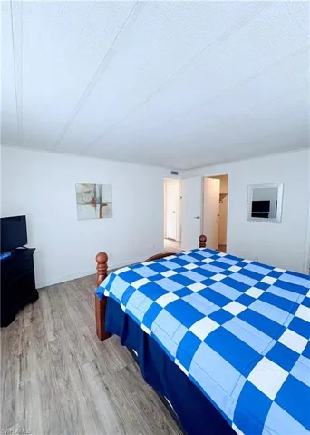 Bedroom featuring light wood-type flooring and a textured ceiling