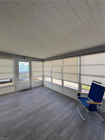 Unfurnished sunroom featuring wood finished floors