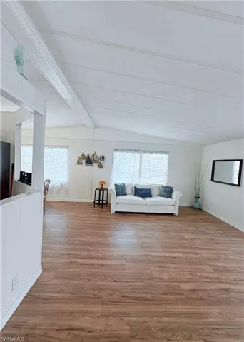 Living area with healthy amount of natural light and light wood-style flooring
