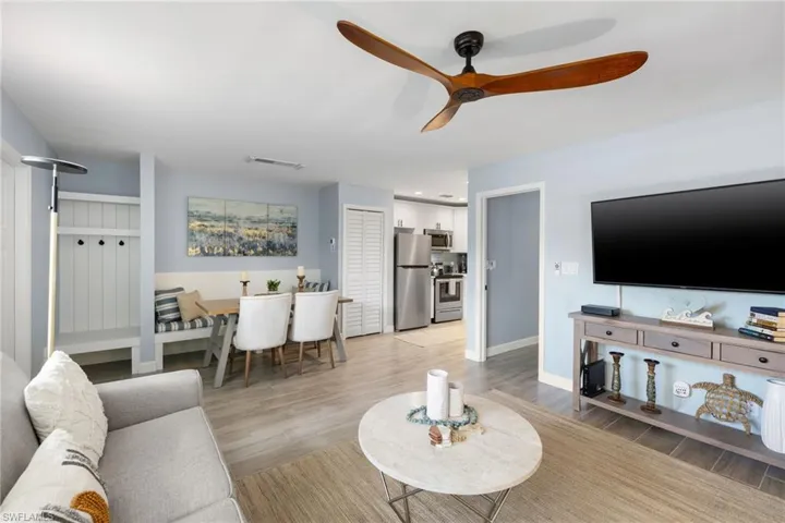 Living area featuring light wood-style flooring and ceiling fan