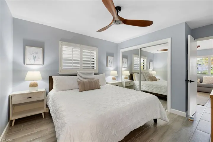 Bedroom featuring wood finish floors, a closet, and a ceiling fan