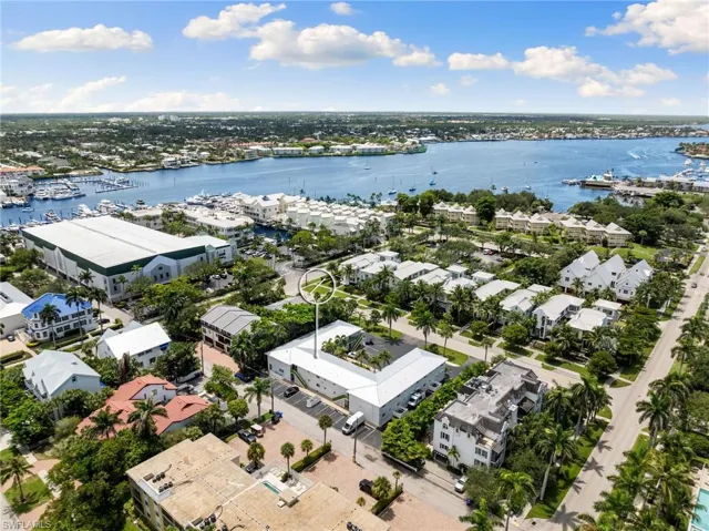 Drone / aerial view of a nearby body of water and a marina