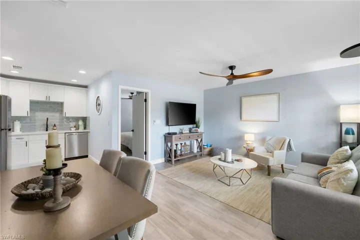 Living area featuring a ceiling fan, light wood-style floors, and recessed lighting