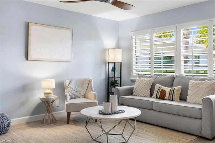 Living room featuring wood finished floors and ceiling fan