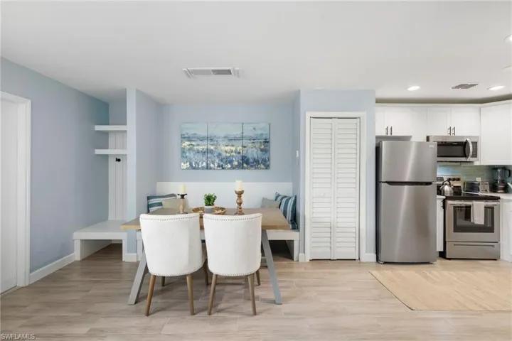 Dining area featuring light wood-style flooring and recessed lighting