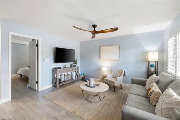 Living room featuring ceiling fan and wood finished floors