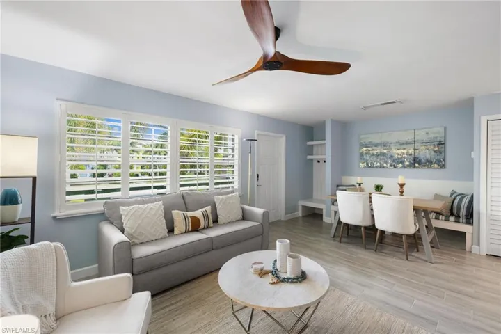 Living area featuring ceiling fan and light wood-style floors