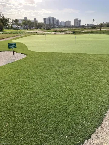 View of community featuring a putting area, golf course view, and a view of city