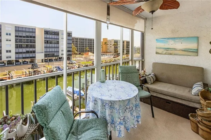 Sunroom featuring a water view