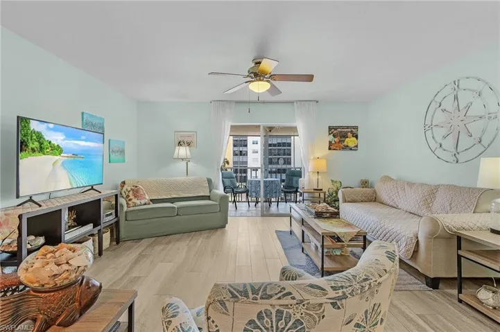 Living area featuring light wood-style flooring and ceiling fan
