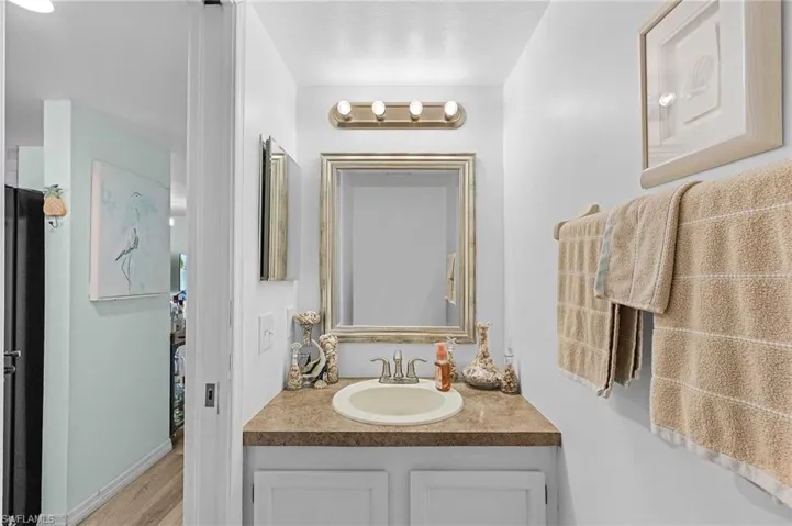 Bathroom featuring vanity and wood finished floors