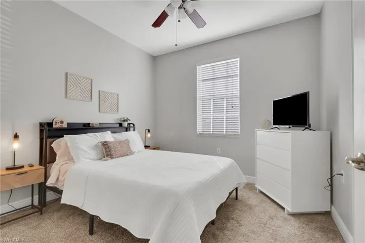 Bedroom featuring light colored carpet and a ceiling fan
