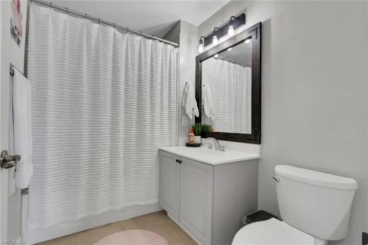 Bathroom with vanity and light tile patterned flooring