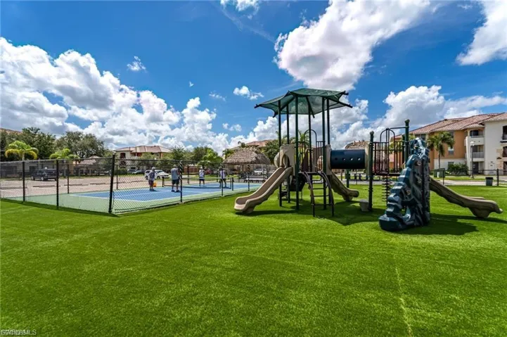 Community playground featuring a tennis court