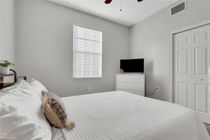 Bedroom with ceiling fan and a closet
