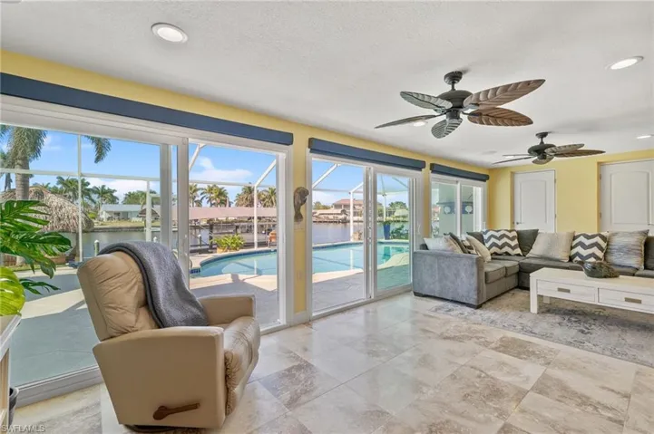 Living Room with view to the pool and dock.
