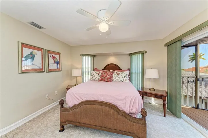 Carpeted bedroom featuring ceiling fan