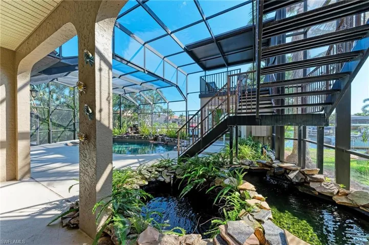 View of patio with a small pond
