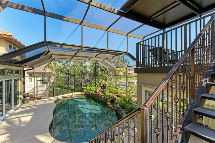View of swimming pool with a patio area and a lanai