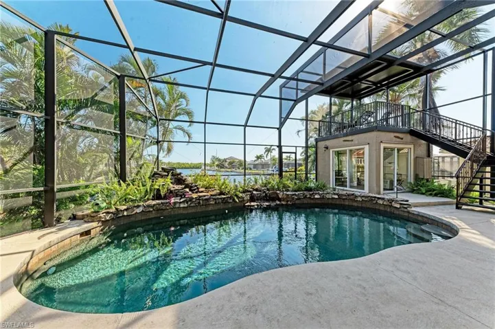 View of pool with a patio area and a lanai