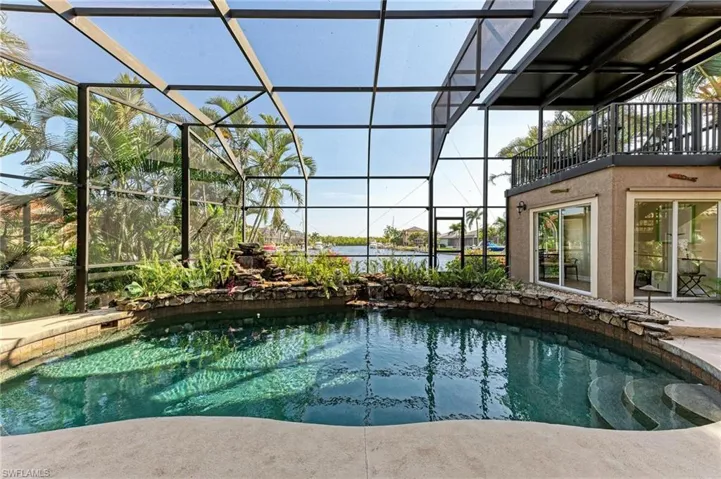 View of pool with glass enclosure