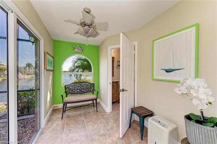Sunroom featuring ceiling fan and lofted ceiling