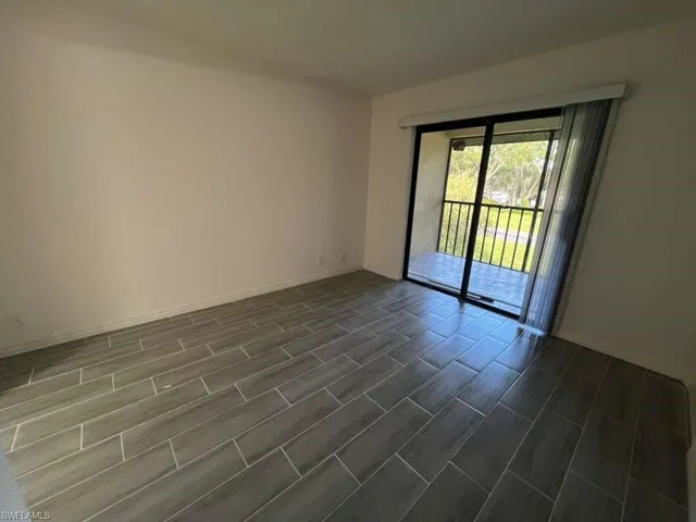 Empty room featuring wood finish floors and baseboards