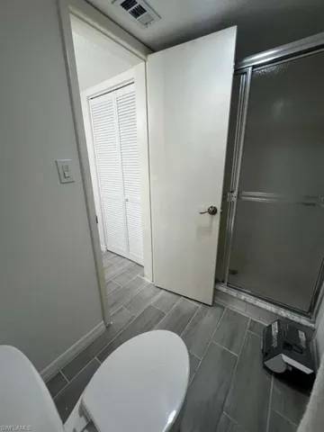 Full bathroom with a stall shower and wood tiled floors
