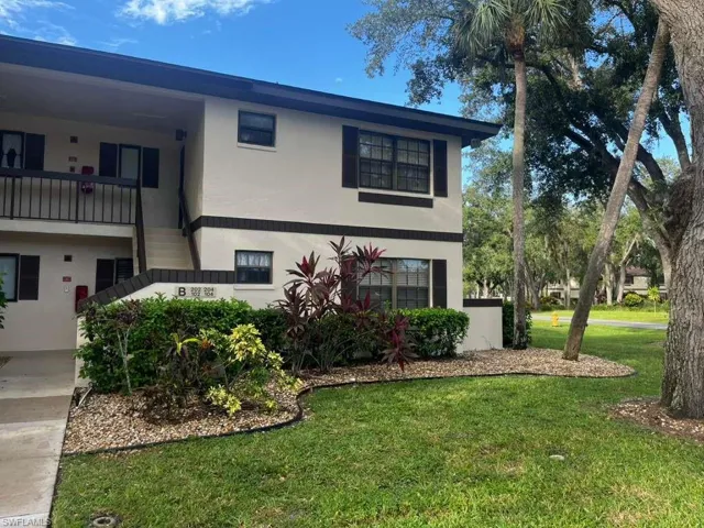 View of front of property with a front lawn and stucco siding