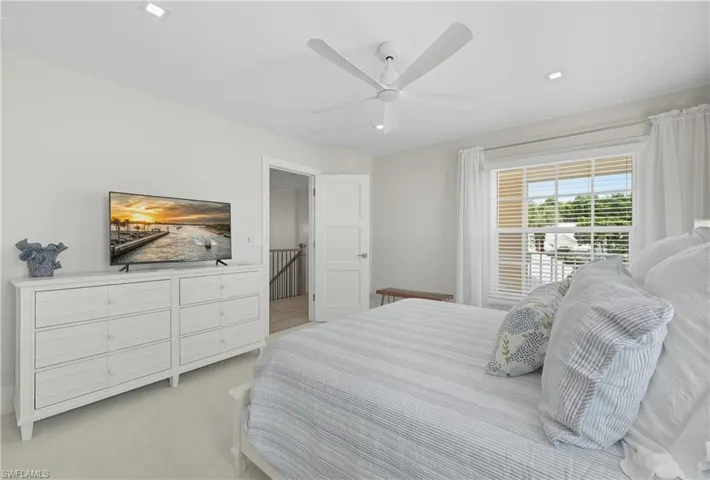 Bedroom featuring a ceiling fan and carpet flooring