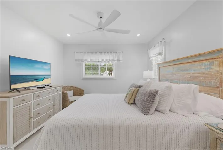 Bedroom with a ceiling fan and recessed lighting