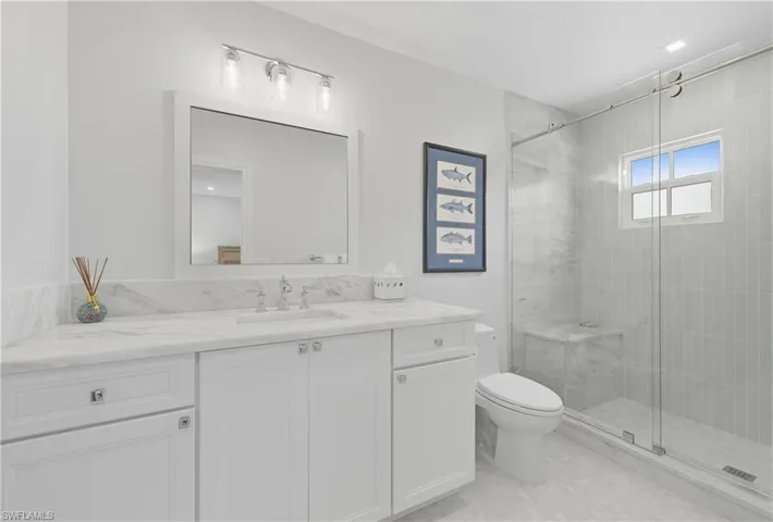 Full bathroom with vanity and a stall shower
