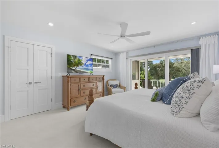 Carpeted bedroom featuring access to exterior, a ceiling fan, and recessed lighting