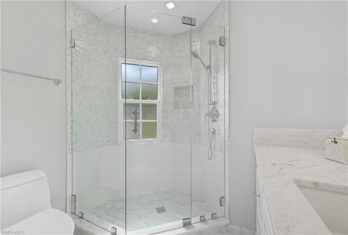 Full bathroom with a stall shower and vanity