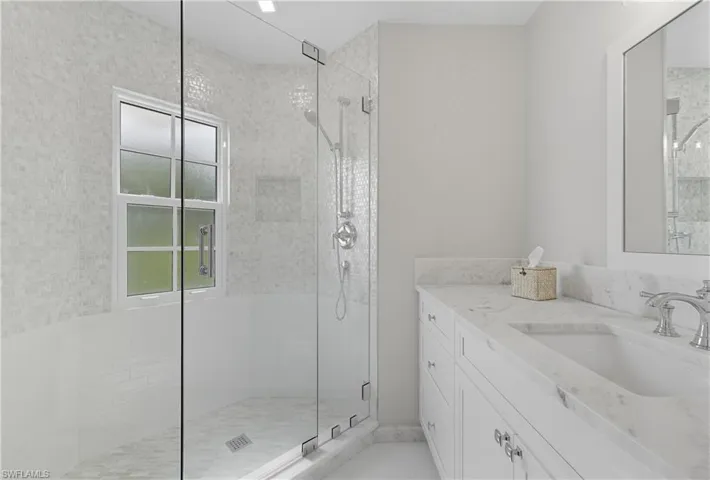 Bathroom with vanity and a shower stall